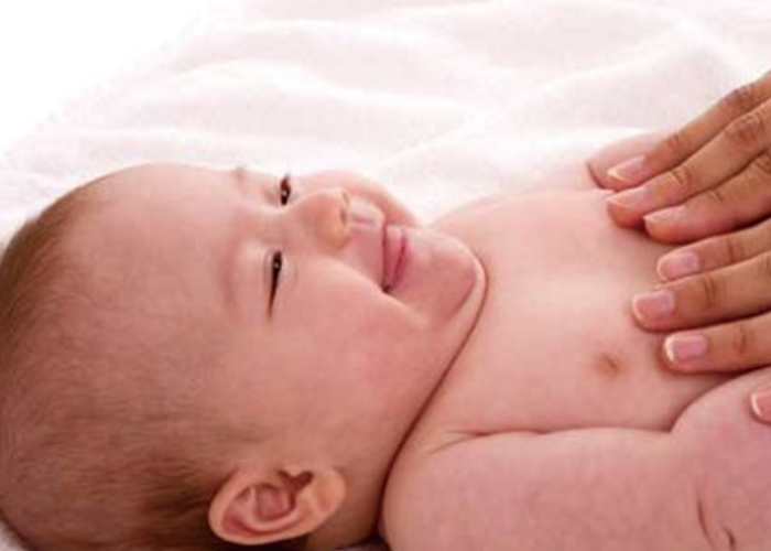 胸に手をあてられて笑顔の赤ちゃん｜不妊治療HP
